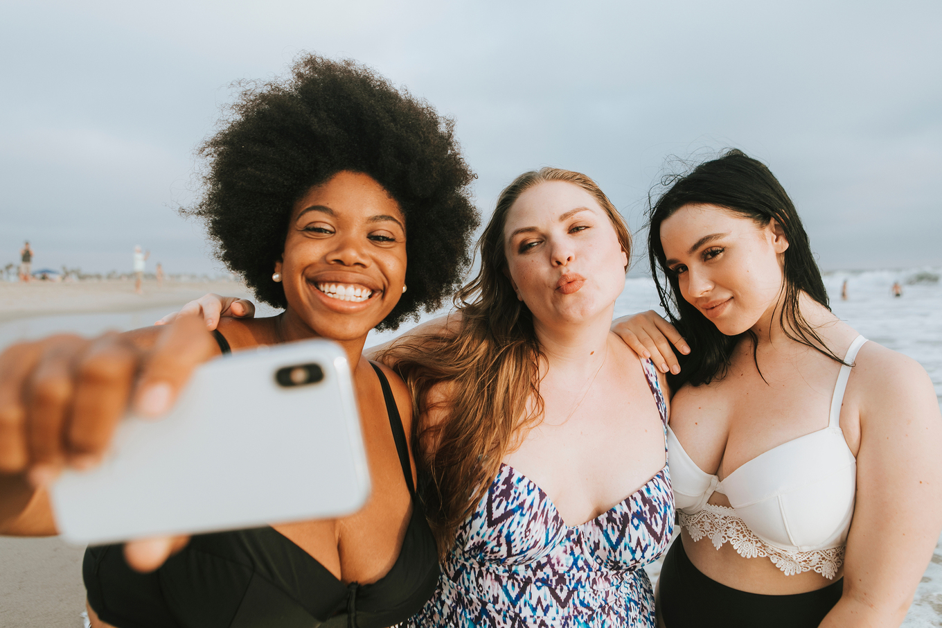 Drei bodypositive Frauen machen Selfie am Strand